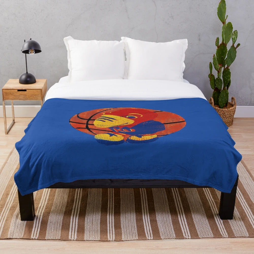 Plush blanket featuring the KU Jayhawks college basketball mascot