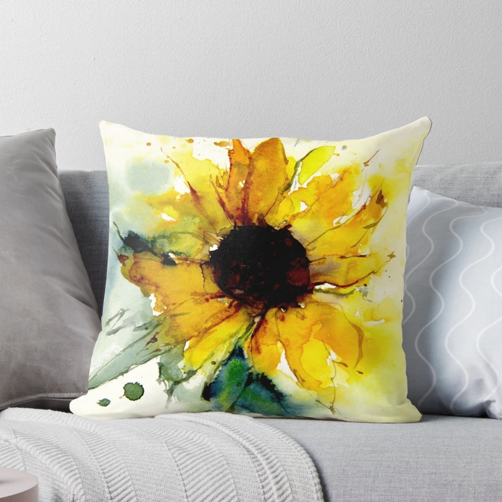 A vibrant sunflower throw pillow featuring a watercolor-style design of yellow flowers and green leaves.