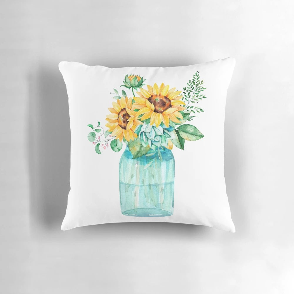 A decorative throw pillow featuring a watercolor painting of sunflowers in a mason jar.