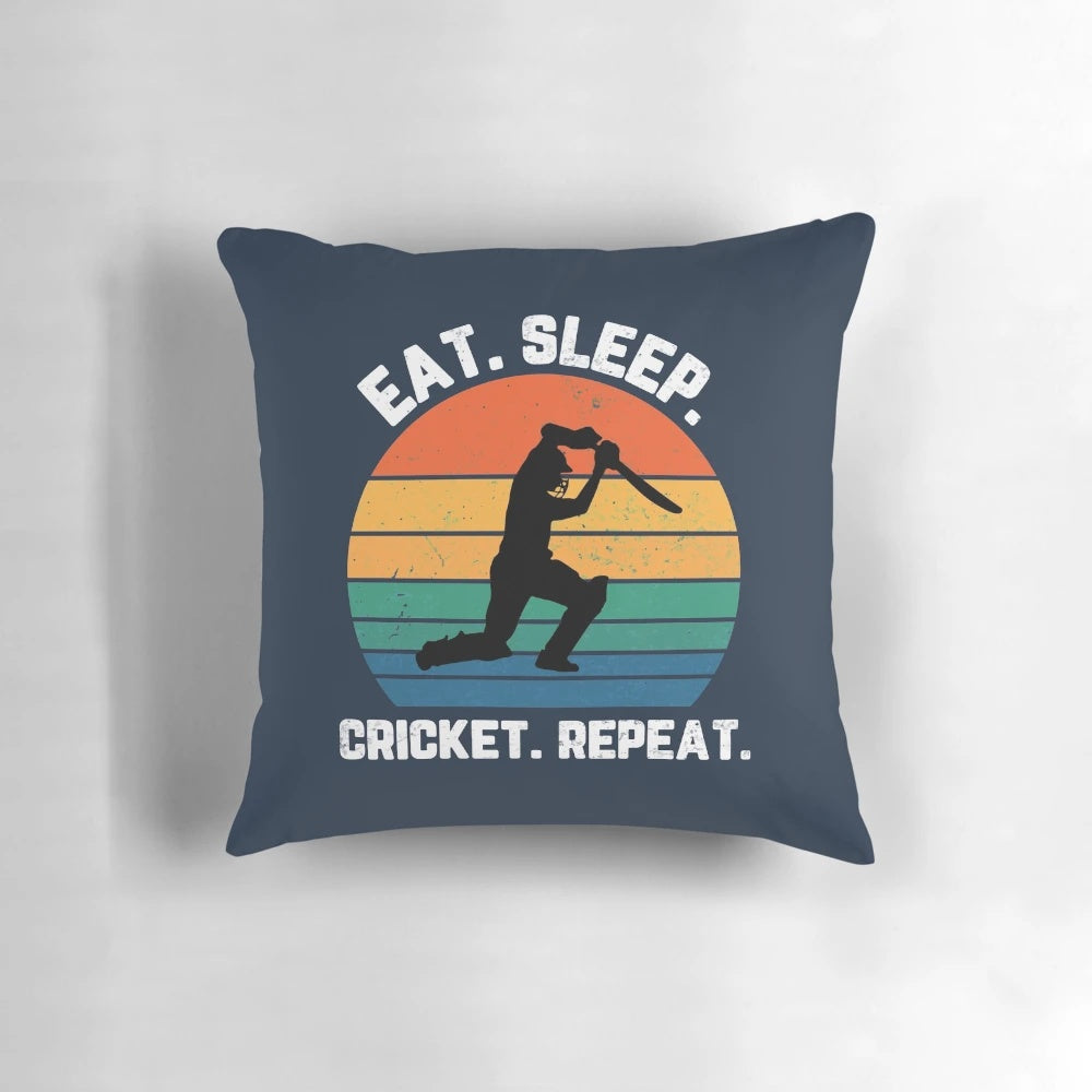 White text pillow with "Eat Sleep Cricket Repeat" design and sunset background