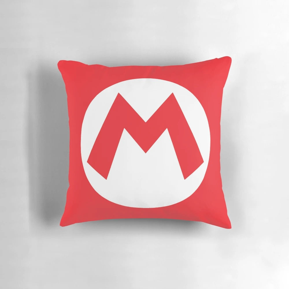 A plush pillow featuring the iconic "M" symbol from the Super Mario video game series, perfect for Halloween decorations or costuming.