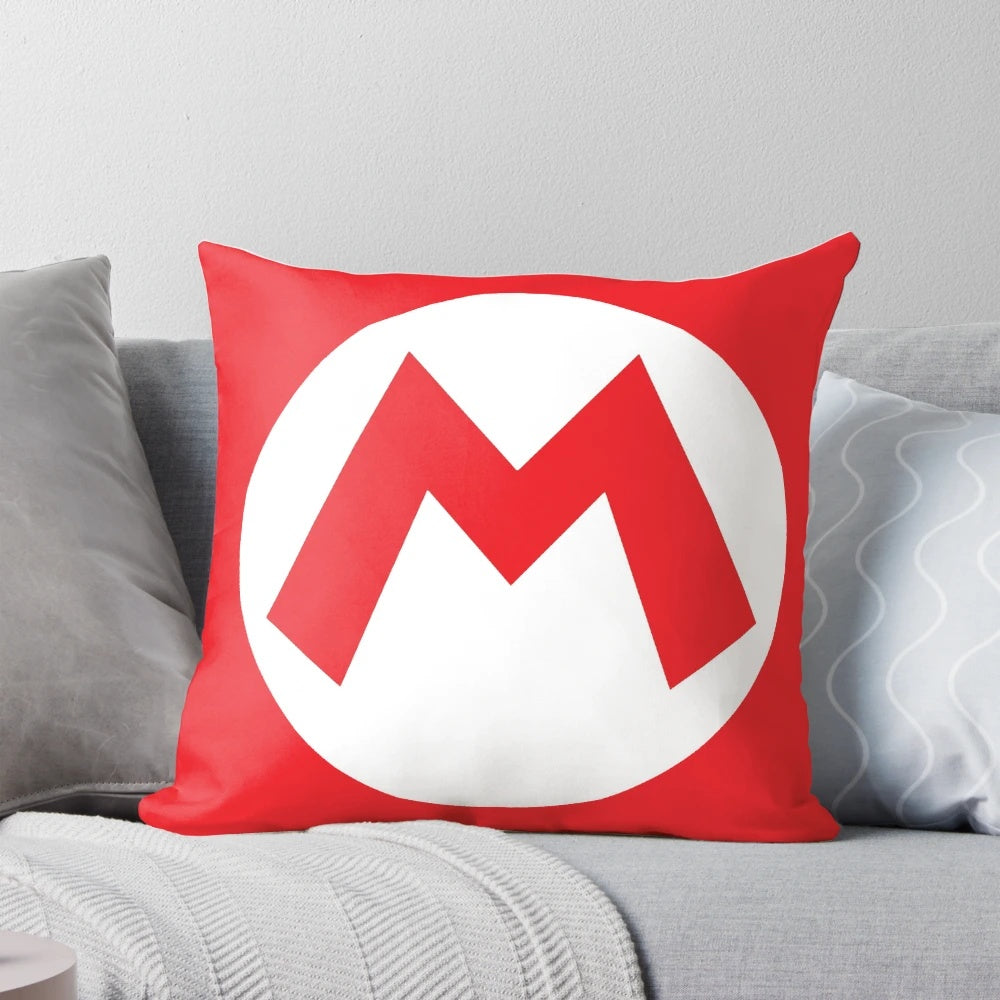 A plush pillow featuring the iconic "M" symbol from the Super Mario video game series, perfect for Halloween decorations or costuming.