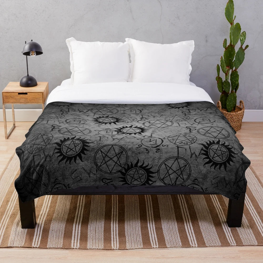Grey plush blanket with supernatural-inspired design