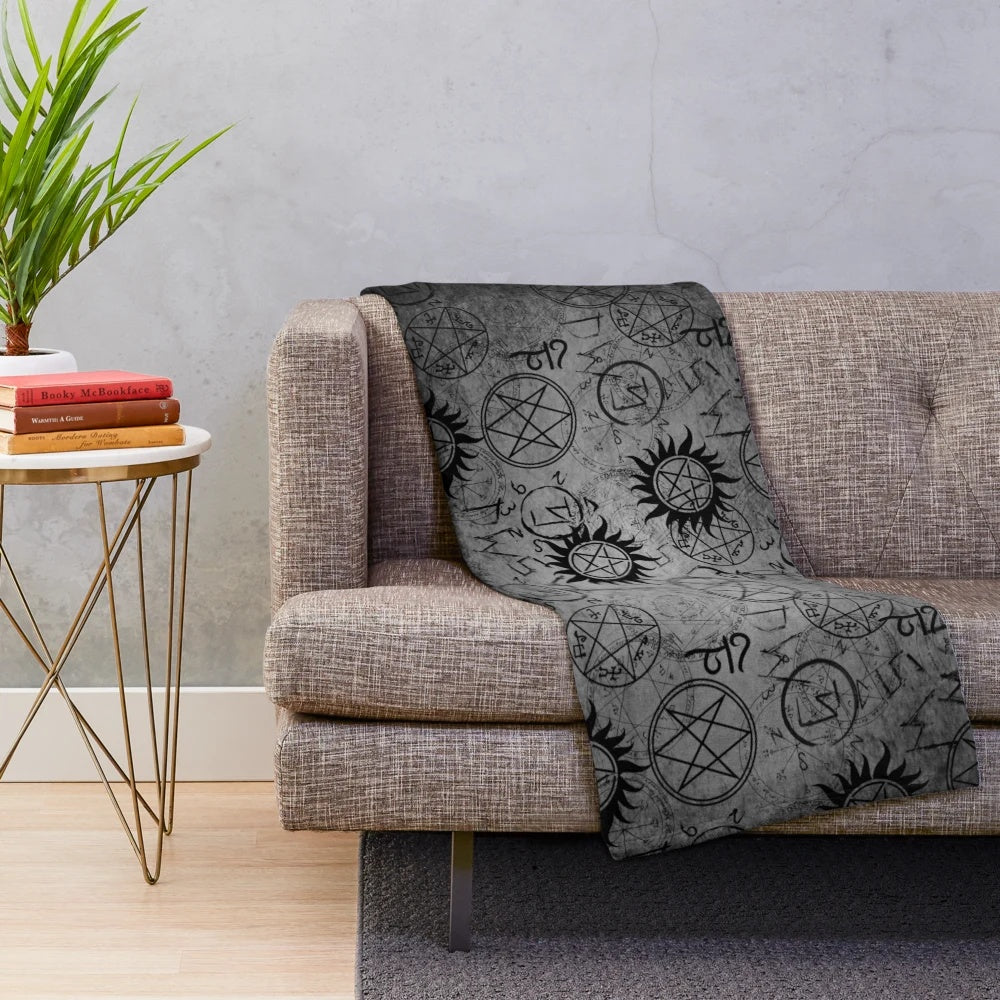 Grey plush blanket with supernatural-inspired design