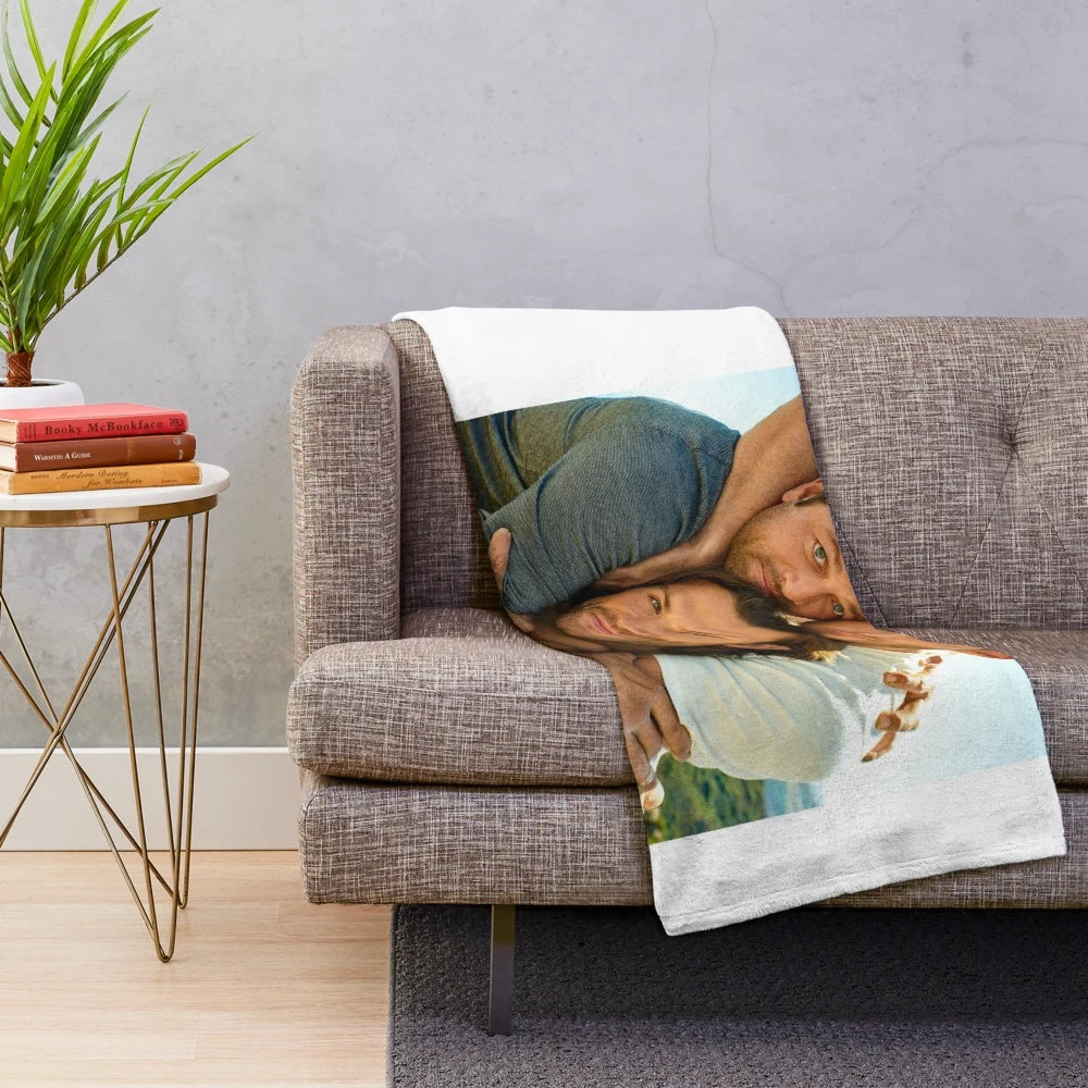 Supernatural-themed plush blanket with illustrations of the Winchester brothers and Castiel