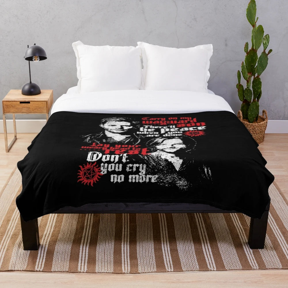 Supernatural-themed plush blanket with characters and symbols