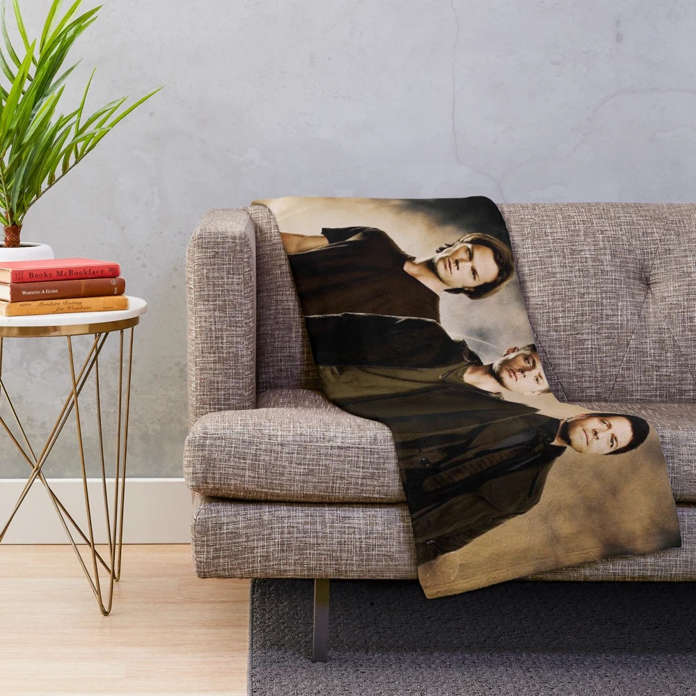 Supernatural-inspired plush blanket featuring Sam, Dean, and Castiel