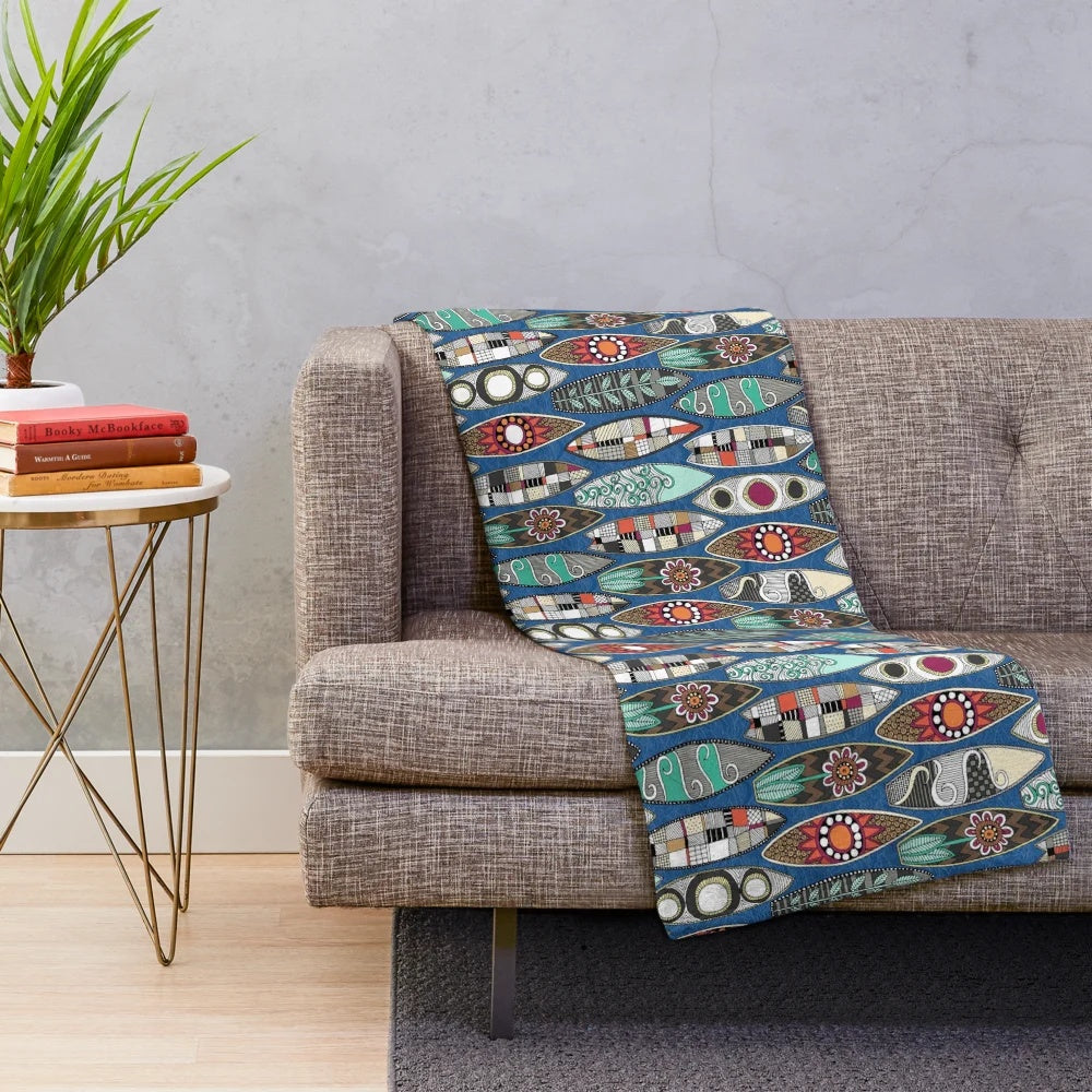 Blue plush blanket with surfboard-inspired graphic design