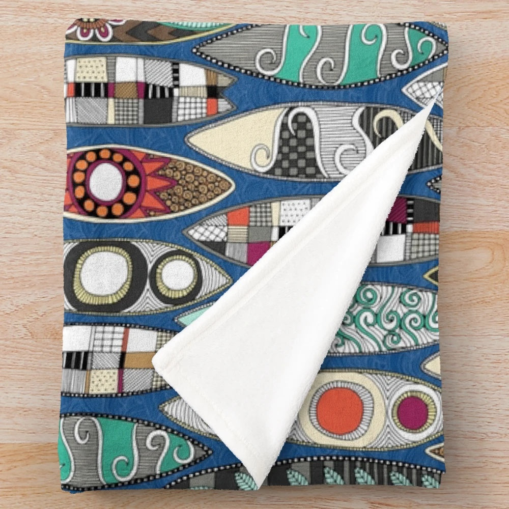 Blue plush blanket with surfboard-inspired graphic design