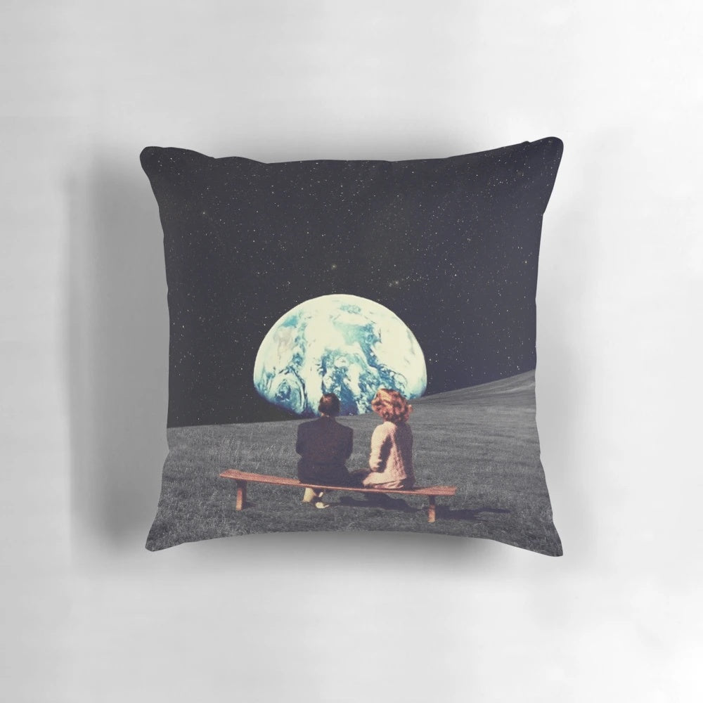 Surreal art pillow depicting a couple in outer space against a dark sky with stars