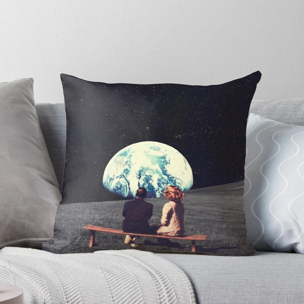 Surreal art pillow depicting a couple in outer space against a dark sky with stars
