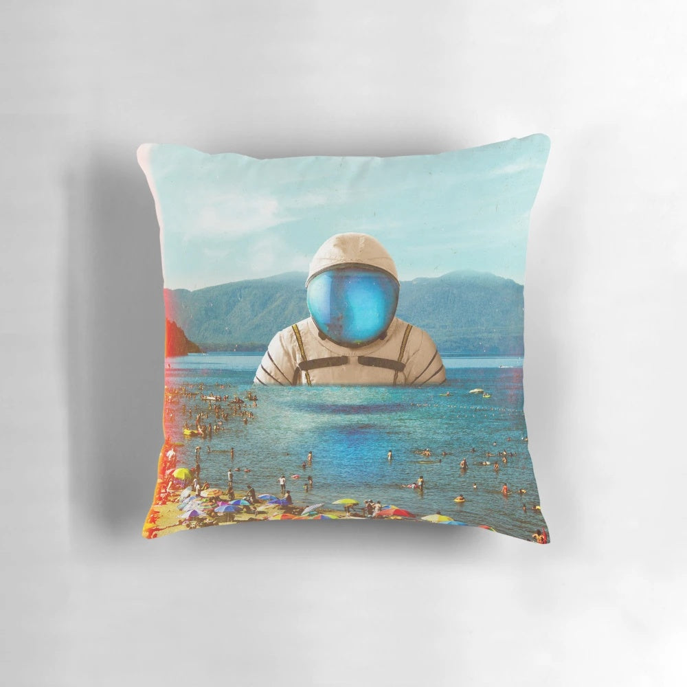 Surreal digital collage pillow featuring an astronaut on a beach against a futuristic, cosmic landscape.