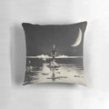 Surreal pillow featuring a dreamscape with a boy, moon, clouds, and water on a dark background