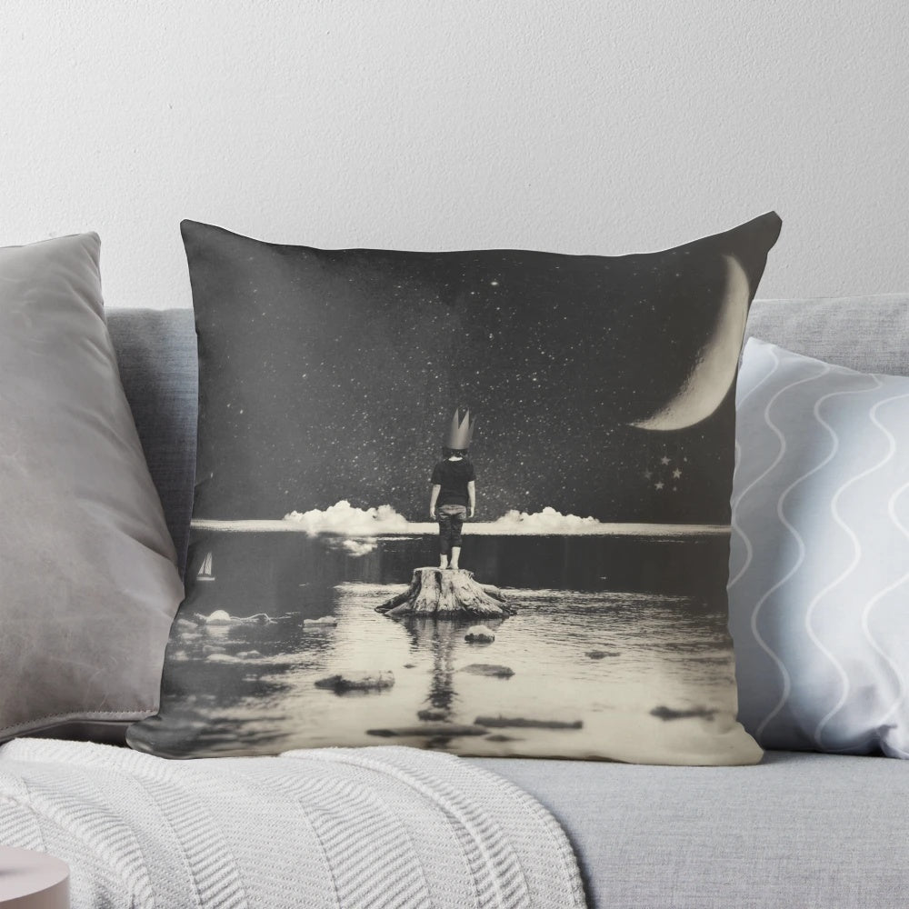 Surreal pillow featuring a dreamscape with a boy, moon, clouds, and water on a dark background