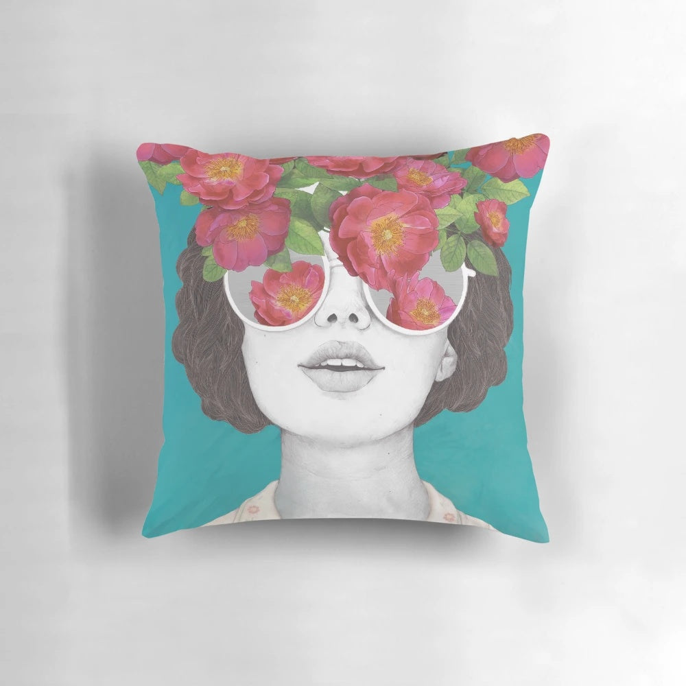 Pillow with a surreal watercolor portrait of a woman wearing rose-tinted glasses and surrounded by flowers