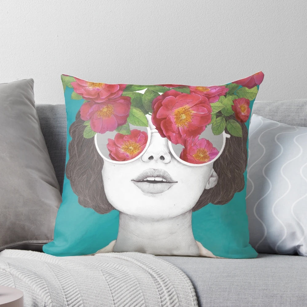 Pillow with a surreal watercolor portrait of a woman wearing rose-tinted glasses and surrounded by flowers