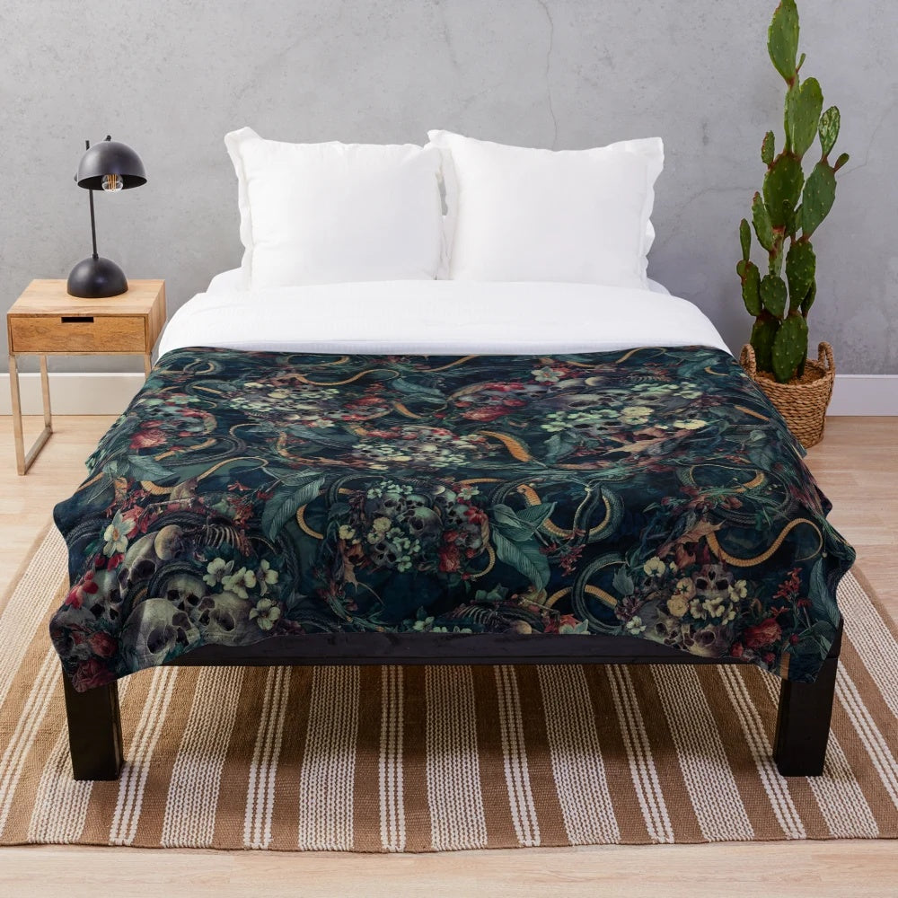 Plush blanket with surreal skull and snake design for dark, contemporary home decor