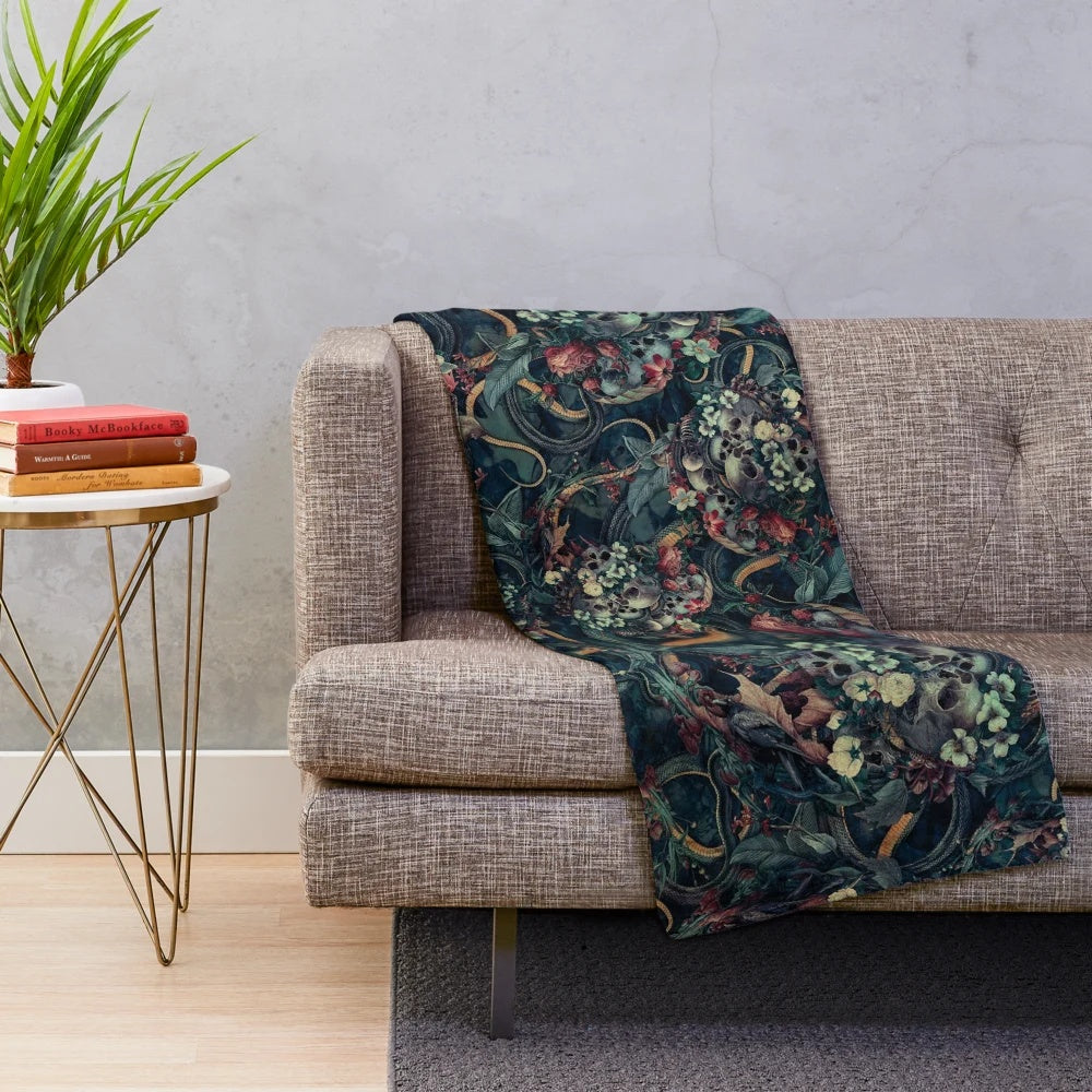Plush blanket with surreal skull and snake design for dark, contemporary home decor
