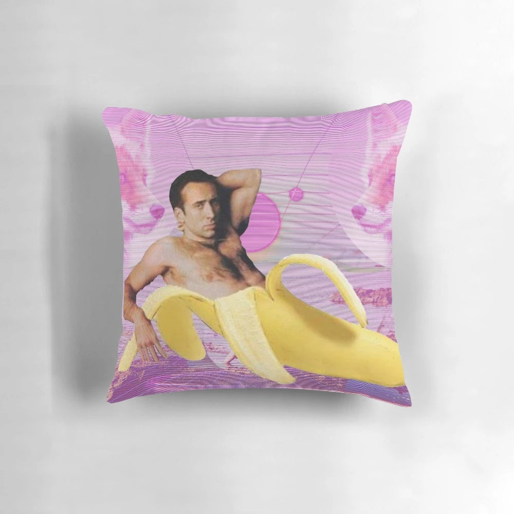 A digital art-style pillow featuring an image of Nicholas Cage's face over a pink and blue vaporwave-inspired background with bananas.