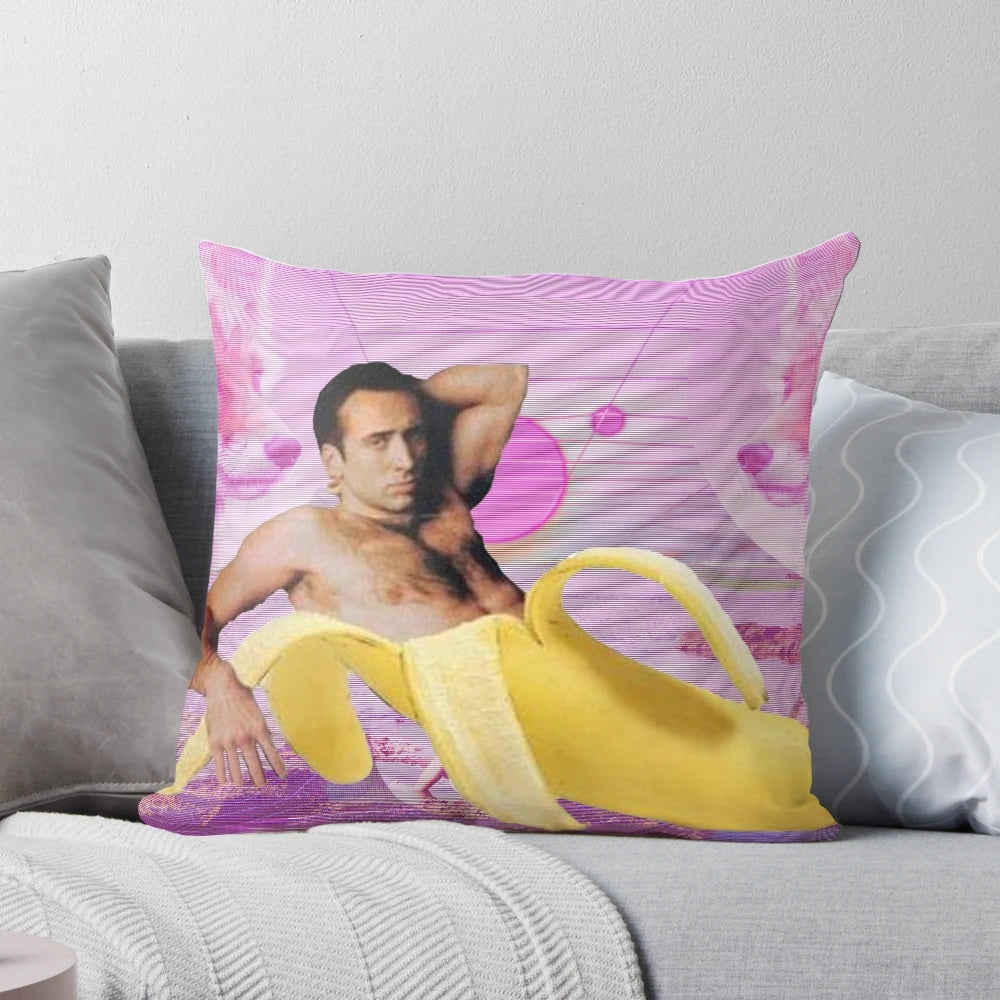 A digital art-style pillow featuring an image of Nicholas Cage's face over a pink and blue vaporwave-inspired background with bananas.