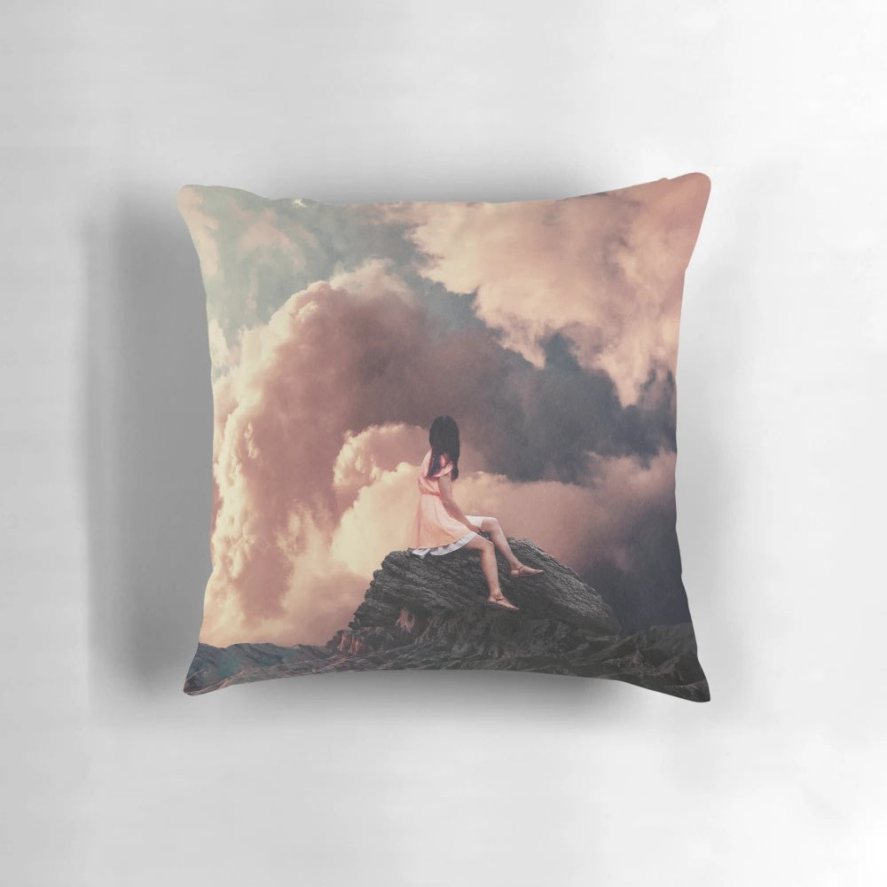 Surreal vintage-style pillow with a collage design of a woman in a landscape with mountains and clouds.