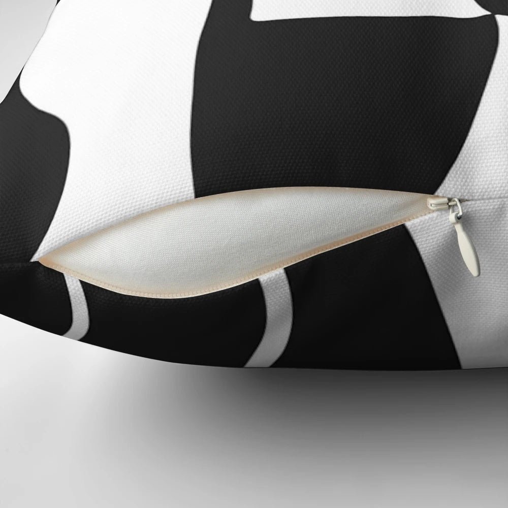 Surrealist black and white throw pillow featuring abstract art inspired by the visionary paintings of Spanish artist Joan Miro.