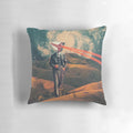 A surrealist digital art pillow featuring a collage of a camera and a dystopian sky landscape with the text "We Are Watching You for Your Own Safety