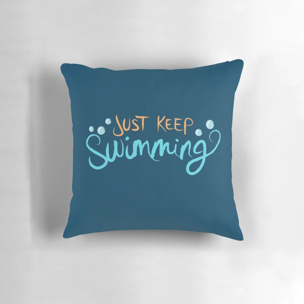 A cozy 'Just Keep Swimming' themed pillow featuring Dory and Nemo from the Disney Pixar film Finding Nemo.