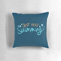 A cozy 'Just Keep Swimming' themed pillow featuring Dory and Nemo from the Disney Pixar film Finding Nemo.