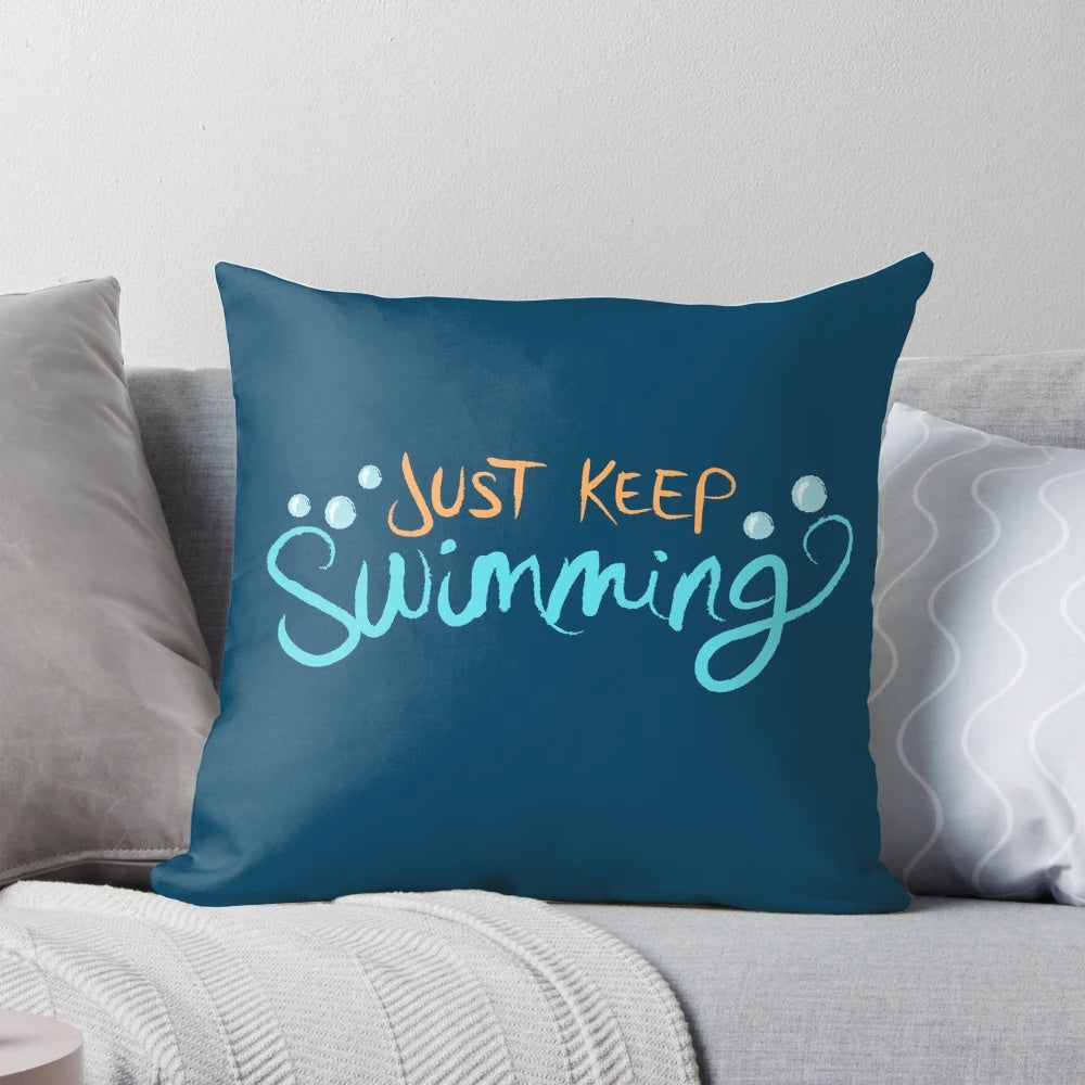 A cozy 'Just Keep Swimming' themed pillow featuring Dory and Nemo from the Disney Pixar film Finding Nemo.