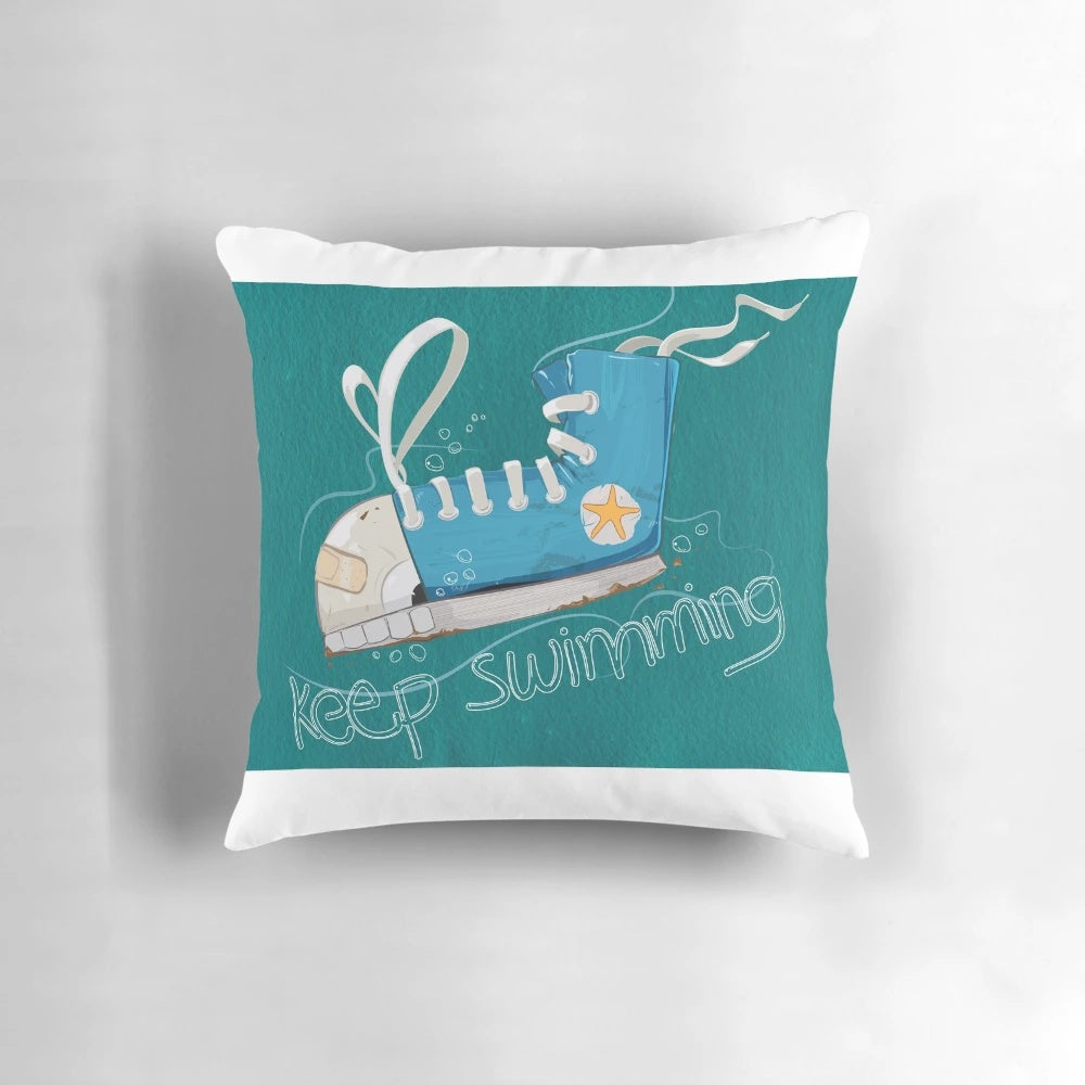 A blue and white pillow with a swimming fish design, perfect for ocean themed home decor.