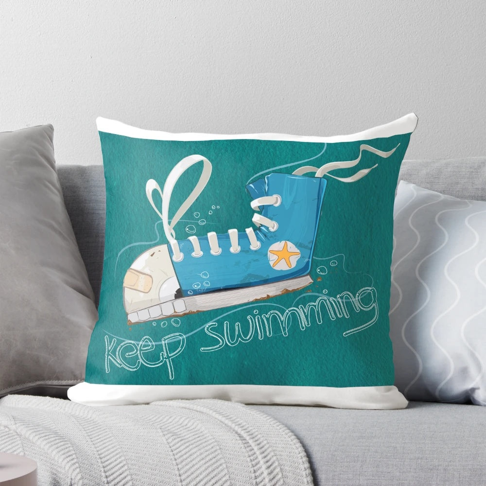 A blue and white pillow with a swimming fish design, perfect for ocean themed home decor.