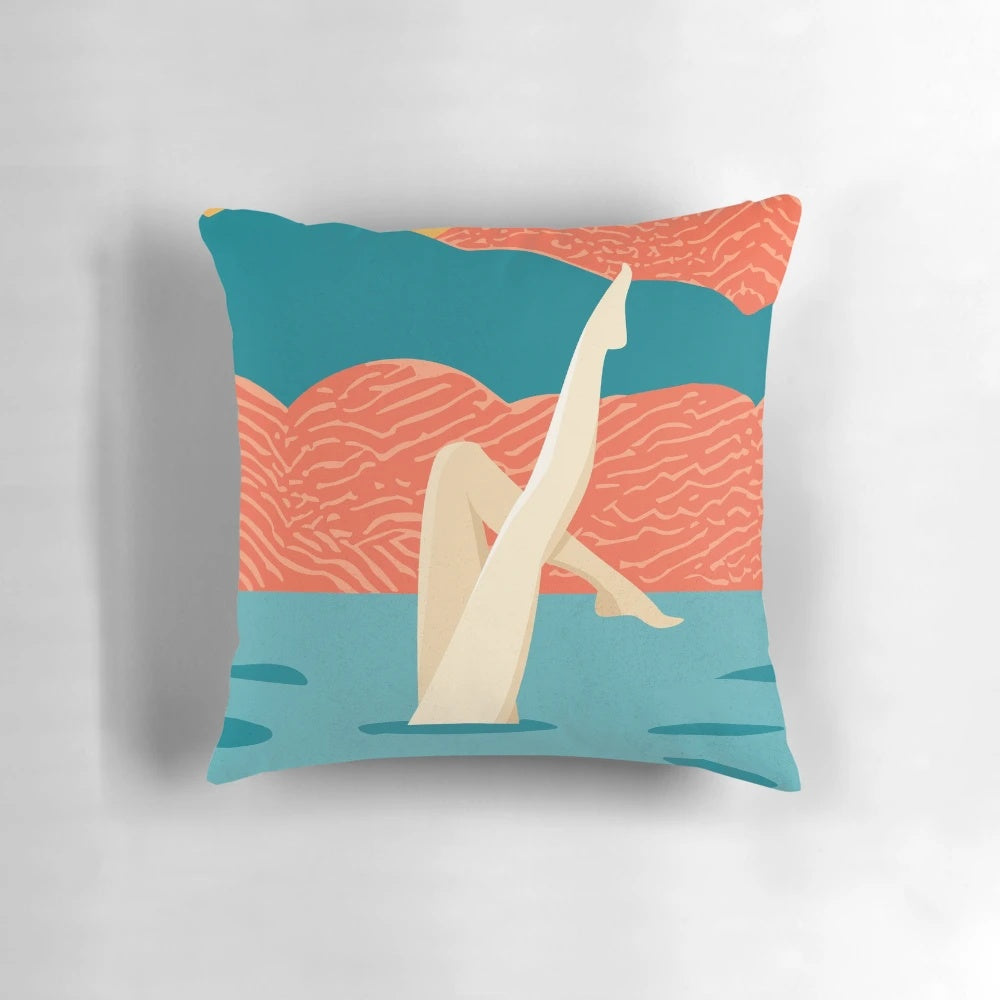 Artistic swimmers performing a synchronized swimming routine on a decorative pillow.