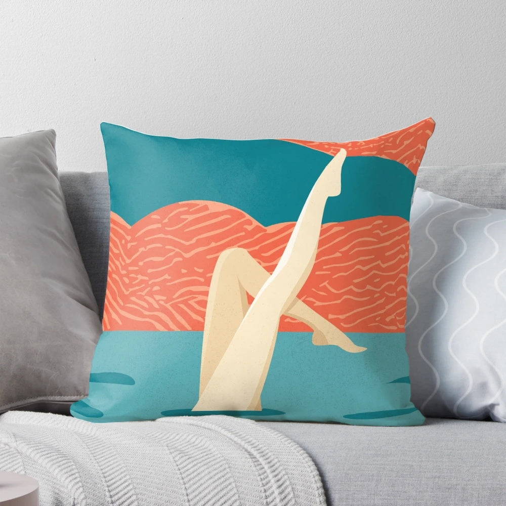 Artistic swimmers performing a synchronized swimming routine on a decorative pillow.