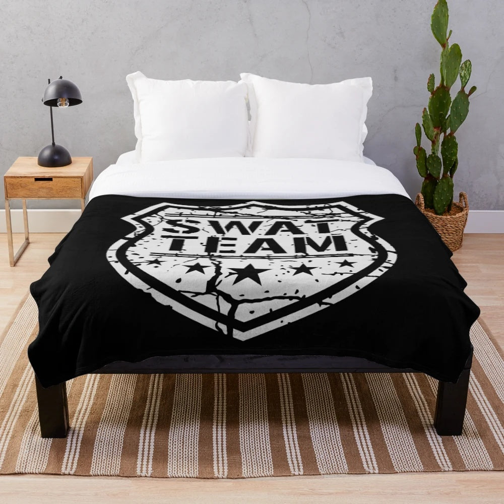 Tactical shield-inspired plush blanket with a distressed, grunge design