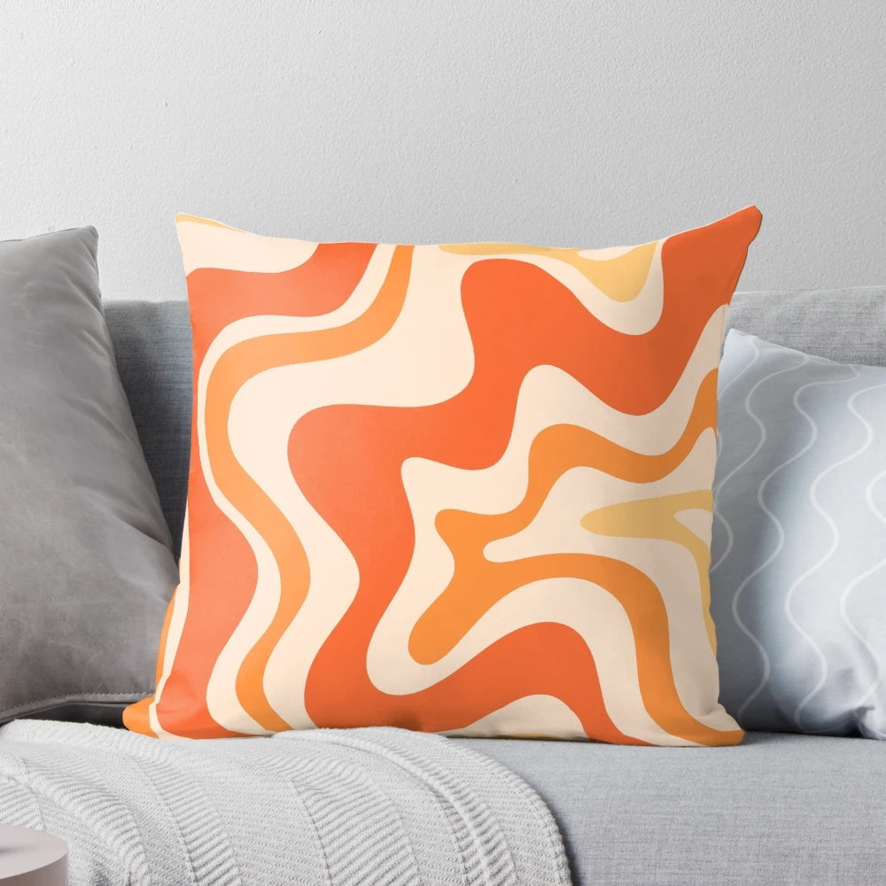 Tangerine-colored abstract swirl pattern on a modern throw pillow