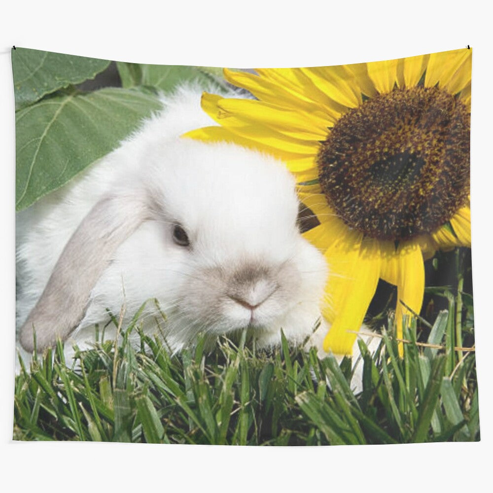 A rabbit relaxing in a garden with a sunflower in the sun