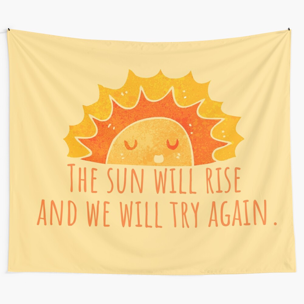 Colorful tapestry with a smiling sun and inspirational quote "The sun will rise and we will try again"