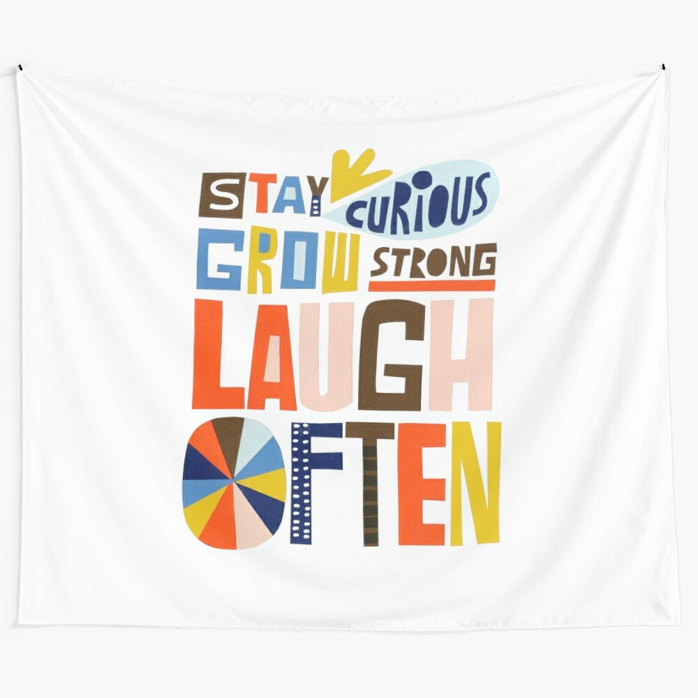 Colorful inspirational tapestry with the words "Stay Curious, Grow Strong, Laugh Often"