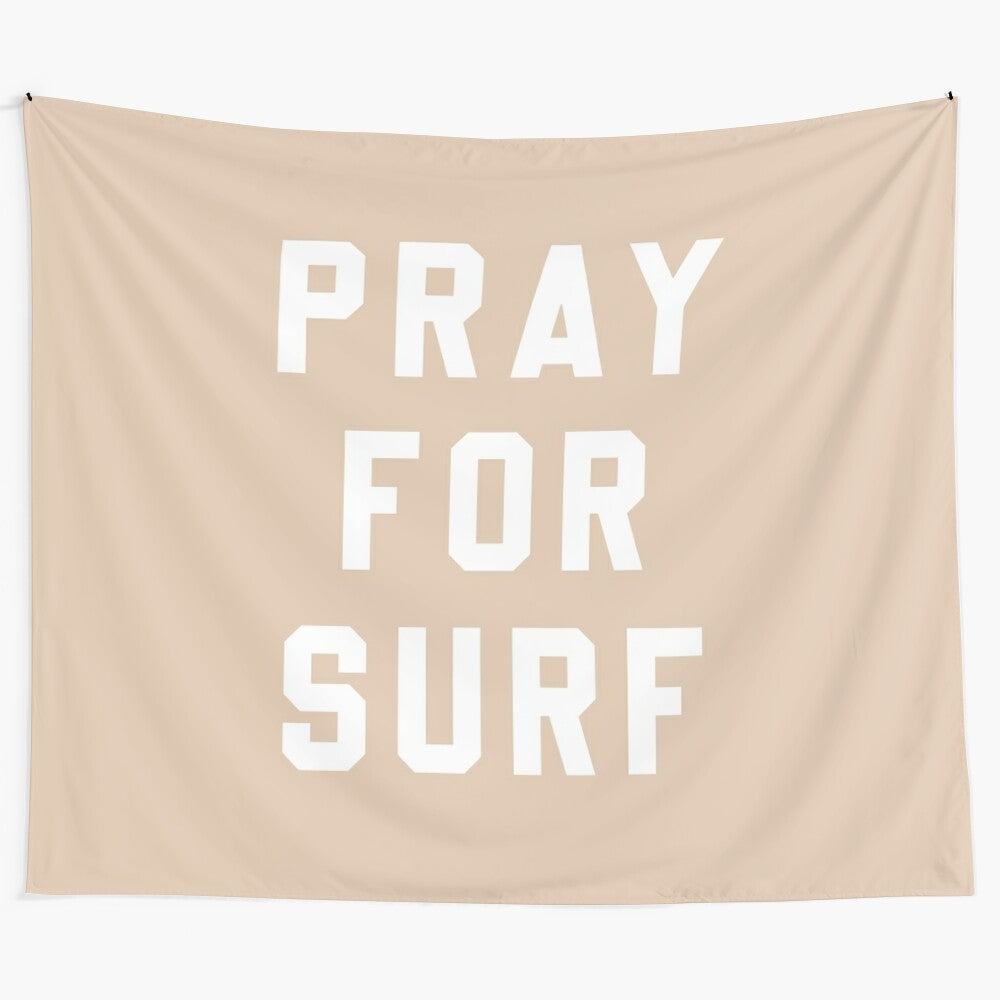 An inspirational sand tapestry with the words "Pray for Surf" in a typographic design