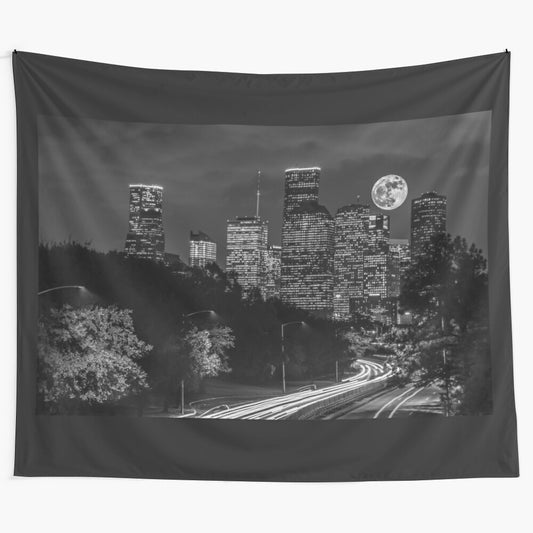 Striking black and white tapestry featuring a dramatic supermoon over the skyline of downtown Houston, Texas