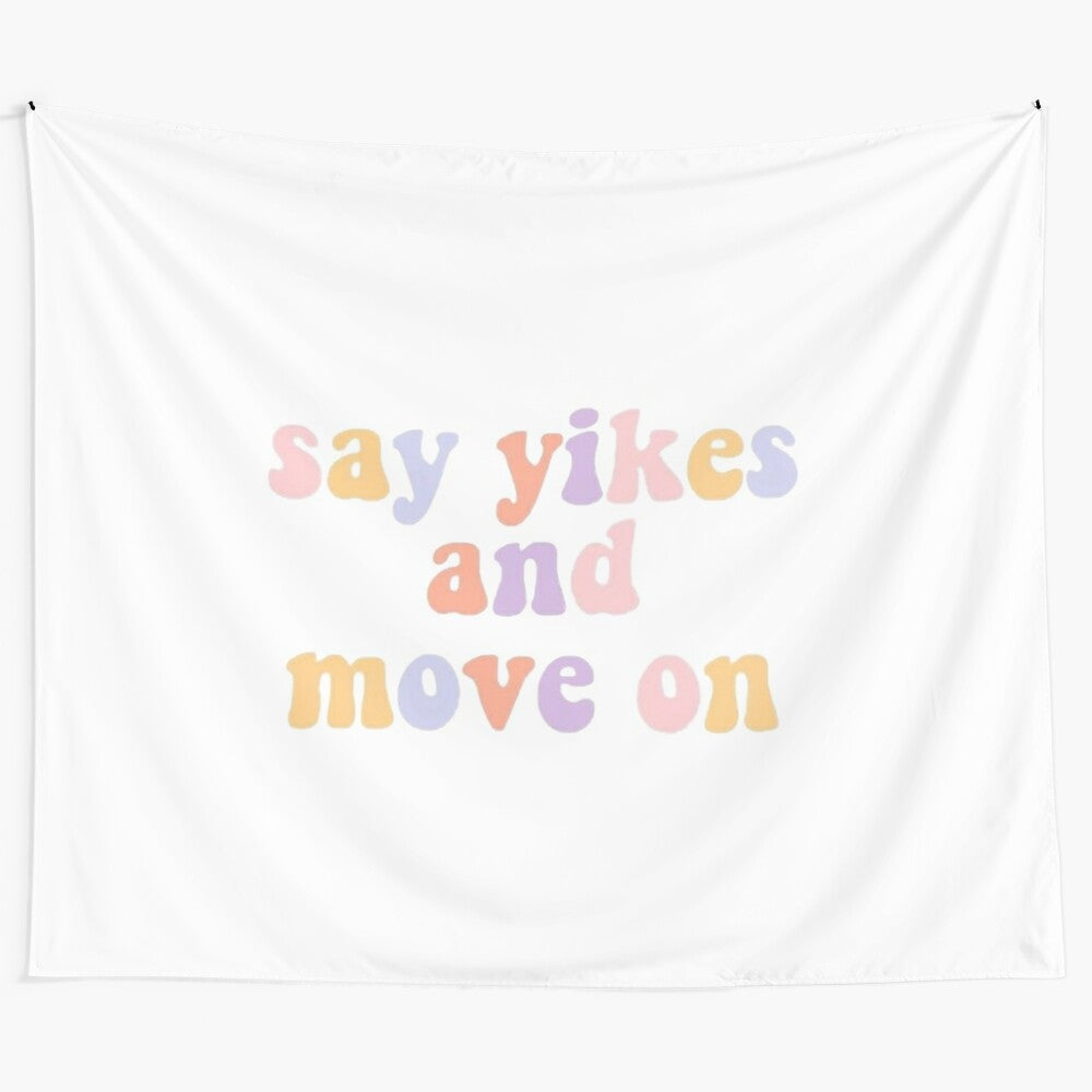 "Say Yikes and Move On" motivational tapestry with pink, yellow, and purple colors