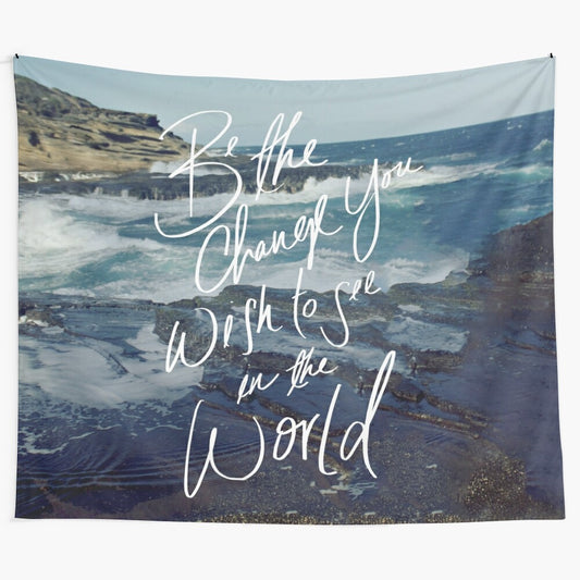 "Be the Change" inspirational quote tapestry with ocean beach background