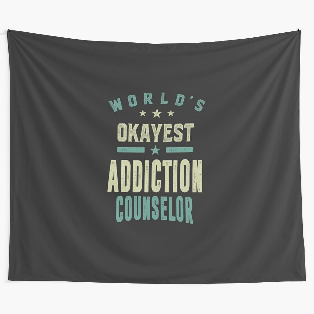 Addiction counselor wall tapestry featuring the text "World's Okayest Addiction Counselor"