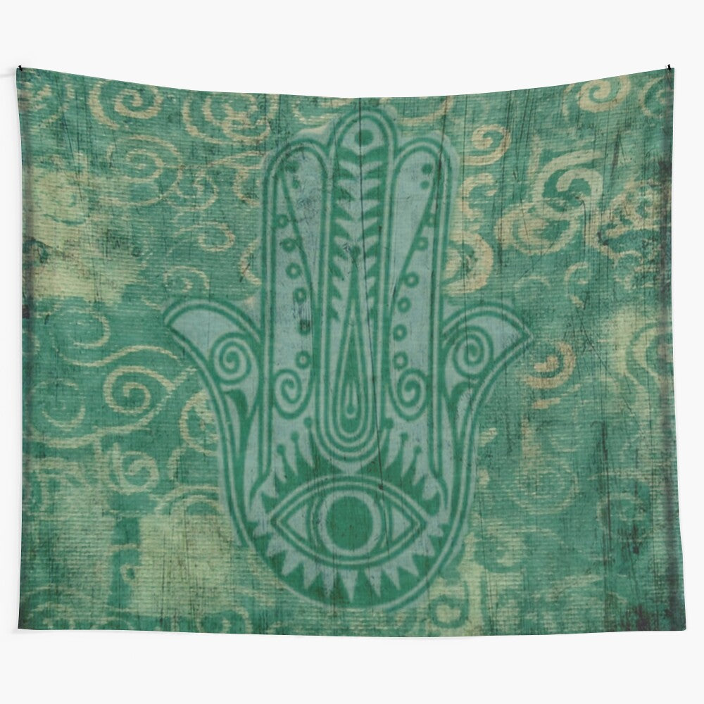 Teal boho tapestry featuring the hand of fatima symbol