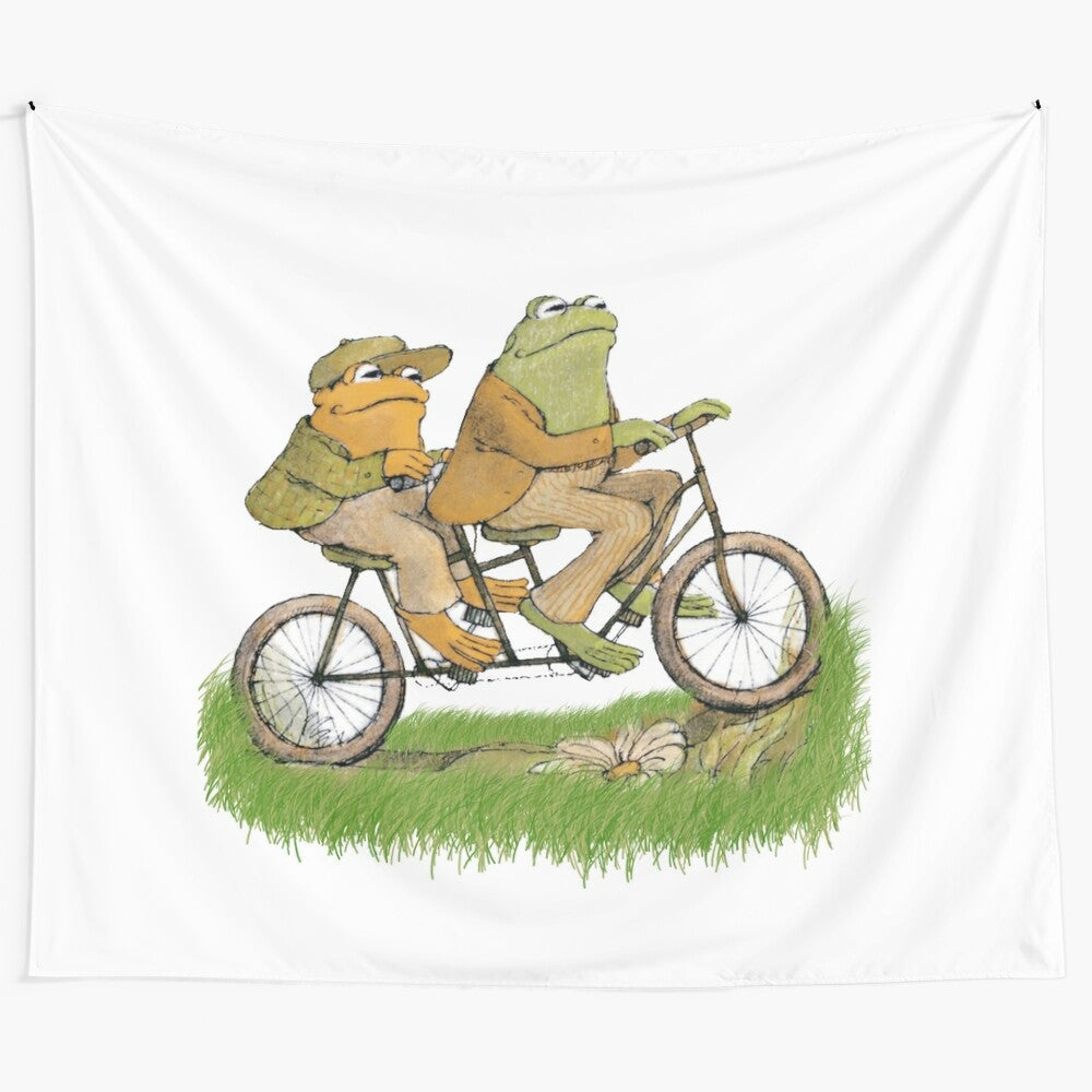 Frog and toad tapestry wall hanging with cute cartoon-style frogs and toads on a bicycle