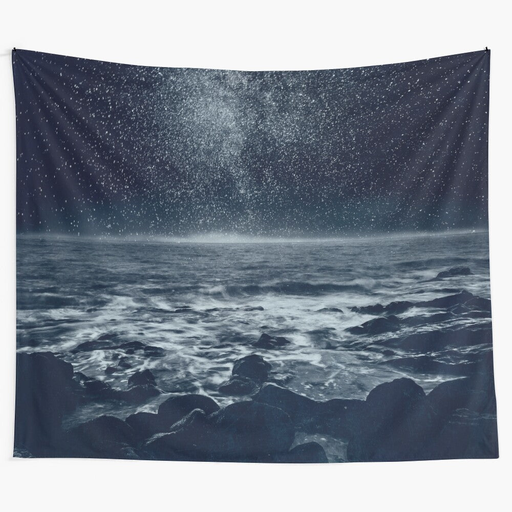 Ethereal ocean tapestry featuring a galaxy and stars over a dark, coastal landscape