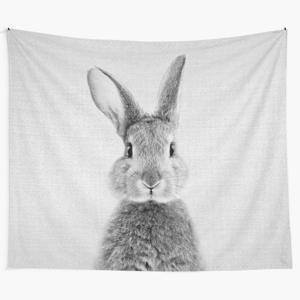 Monochrome wildlife tapestry featuring a playful rabbit