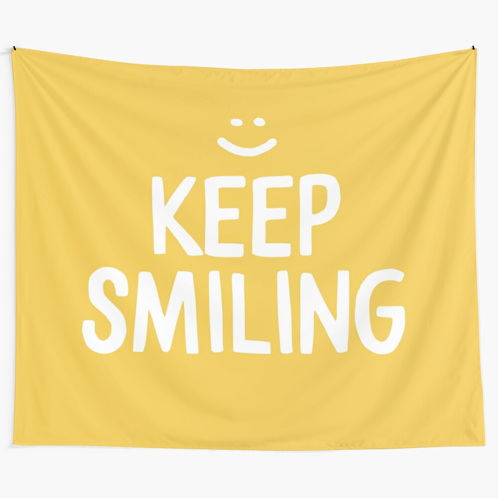 Yellow tapestry with the text "Keep Smiling" and a happy, smiling face design