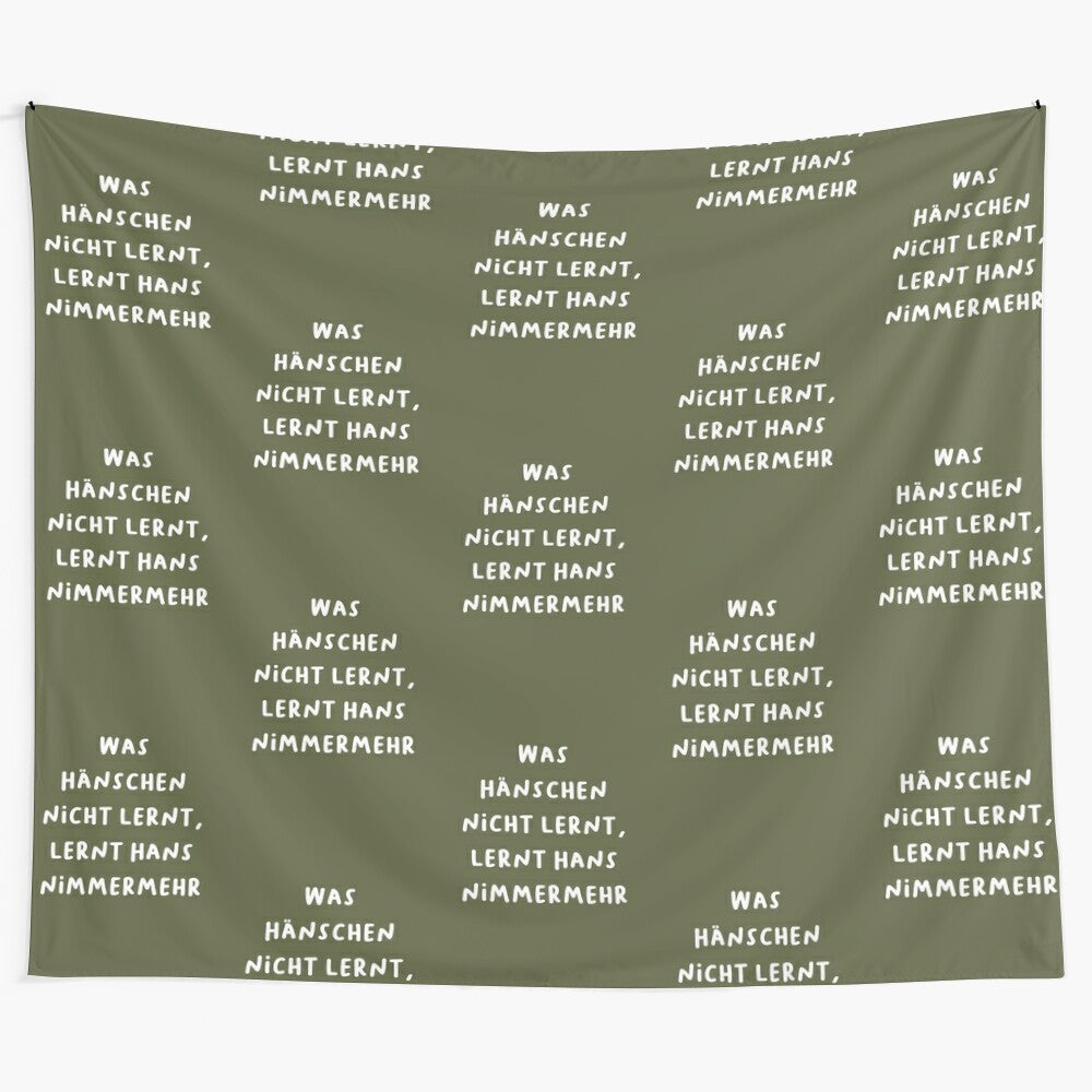 Minimalist tapestry with German proverb "What little Hans doesn't learn, big Hans never will"